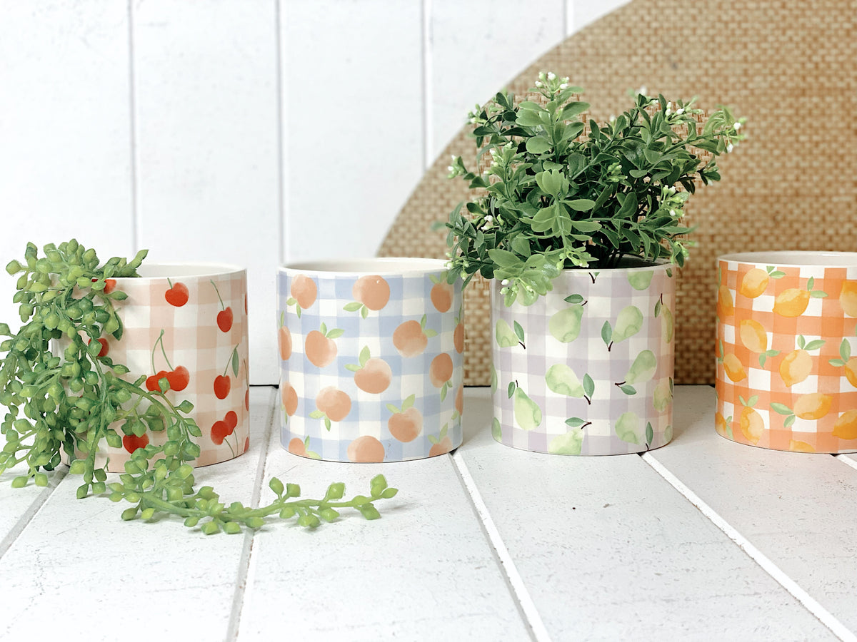 Our gorgeous Tutti Frutti Ceramic Pots create a unique style with bold colours featuring gingham patterns and summer fruits. These pots are perfect to help transform your indoor or outdoor garden with beautiful bright colours. Available in 4 styles. 10x10cm. | Bliss Gifts &amp; Homewares | Unit 8, 259 Princes Hwy Ulladulla | South Coast NSW | Online Retail Gift &amp; Homeware Shopping | 0427795959, 44541523